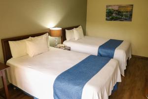 En eller flere senge i et værelse på Posada de Tampico