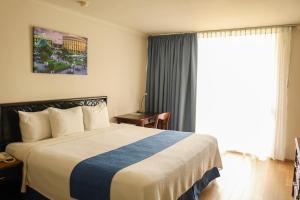 En eller flere senge i et værelse på Posada de Tampico