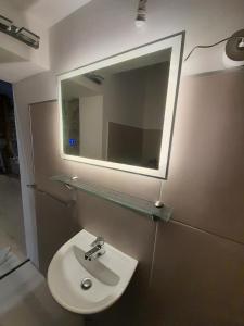 a bathroom with a sink and a mirror at sofitsasplace in Kokkari