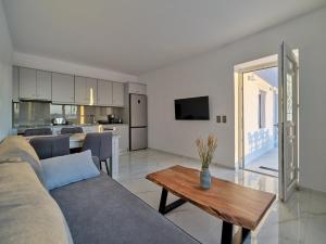 a living room with a couch and a table at Climata House in Parikia +8 photos
