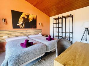 a bedroom with two beds and a picture of an elephant at Casa Hermanos by Costabravaway in Calonge +78 photos