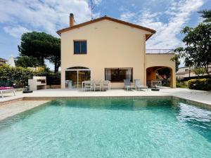 a villa with a swimming pool in front of a house at Casa Hermanos by Costabravaway in Calonge