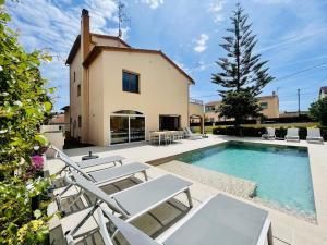 a villa with a swimming pool and a house at Casa Hermanos by Costabravaway in Calonge