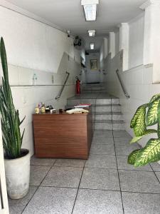 a waiting room with stairs and a reception desk at Hot Iguaçú in Sorocaba