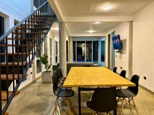 a table and chairs in an office with a staircase at Villa Entre Nubes in El Hatillo