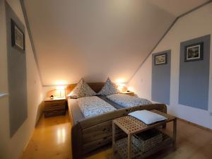 a small room with a bed and two lamps at Ferienwohnungen Haus Marianne in Langscheid