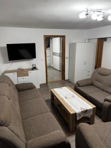 a living room with two couches and a coffee table at Apartman Ana in Bjelovar