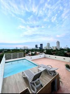 a swimming pool on the roof of a building at Departamento completo en Asuncion A3 in Asuncion