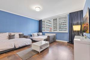 a living room with a bed and a couch at Tomato Apartment - With free parking in Bratislava
