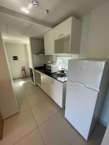 a kitchen with a white refrigerator and a counter at Departamento completo en Asuncion A3 in Asuncion