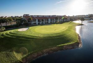an aerial view of a golf course with a building at Edgewater Golf Villa 1210 in Panama City Beach