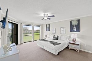 a bedroom with a bed and a ceiling fan at Edgewater Golf Villa 1210 in Panama City Beach +21 photos