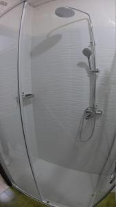 a shower with a glass door in a bathroom at Casa Anì in Mirano +12 photos