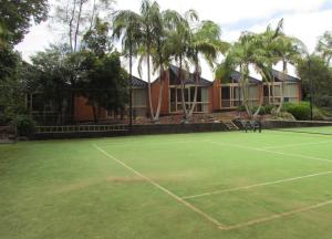 a tennis court with a tennis racket on it at Shelly Beach Resort in Port Macquarie