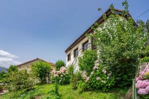 a house with flowers on the side of it at Casa Honorato en la montaña in Santa Eulalia