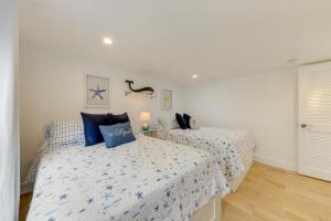 a bedroom with two beds with blue pillows at Lanai, Pool and Patios Waterfront Home in Tavernier in Tavernier +19 photos