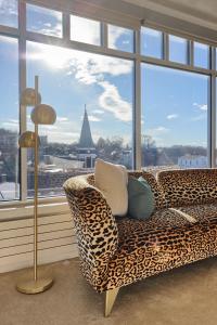 a leopard print couch in a room with a large window at The Executive Suites and Events in Ephrata