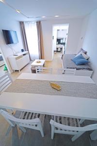 - un salon avec une table blanche et un lit dans l'établissement NOR 404 - Departamento de categoría con hermosas vistas, à Ushuaia