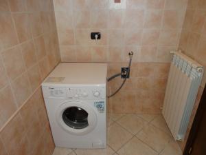 a washer and dryer in a small bathroom at Salento Sweet Home in Melissano