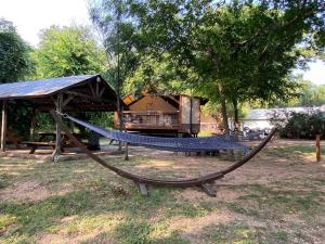a hammock in a park with a gazebo at Safari Cabin A in Seguin