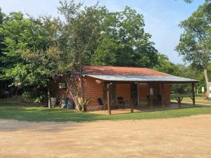 a small brick building with a metal roof at Safari Cabin A in Seguin