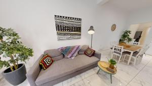 a living room with a couch and a table at Seaside Apartment Steps Away From The Sea in Il-Gżira +15 photos