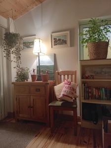 a room with a chair with a pillow on it at Beautiful 3 Bedroom House in Ennistymon +12 photos