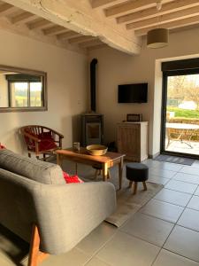 a living room with a couch and a table at Gîte de la Pisserotte in Montigny-sur-Armançon