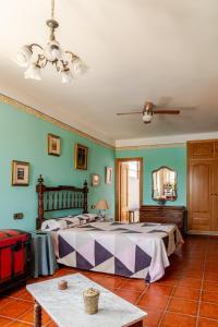 a bedroom with a large bed and green walls at Casa Rural La Casona in Casas de Juan Núñez