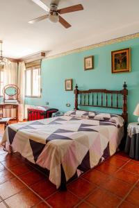 a bedroom with a large bed with blue walls at Casa Rural La Casona in Casas de Juan Núñez