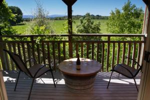 a wooden bench sitting in the middle of a patio at Margrain Vineyard Villas in Martinborough