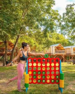 a woman playing with a giant lego game at Waterfront Prairie Flower Treehouse in Seguin