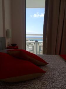 a bedroom with a bed with a view of the ocean at Ponderosa Holiday Studio 701 in Playa de las Americas +35 photos