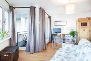 a living room with a couch and a table at The Maybach - rooftop living XBerg, 1BR, 1 living room, group & family friendly, 2 - 4 Guests in Berlin