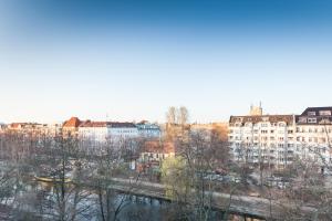 a view of a city with buildings and a river at The Maybach - rooftop living XBerg, 1BR, 1 living room, group & family friendly, 2 - 4 Guests in Berlin