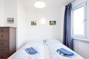 a bedroom with a bed with blue curtains and a window at GreatStay Apartment - Maybachufer in Berlin