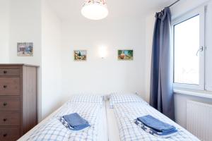 a bedroom with a bed with blue curtains and a window at The Maybach - rooftop living XBerg, 1BR, 1 living room, group & family friendly, 2 - 4 Guests in Berlin
