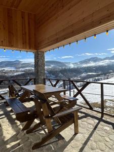 a picnic table and chairs on top of a mountain at Shahdag Nature House in Qusar