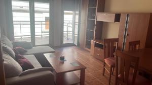 a living room with a couch and a table at Baltar in Sanxenxo