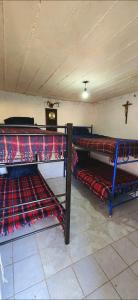 two bunk beds in a room with a ceiling at Quinta El Cocula camping, cabañas y eventos in San Miguel