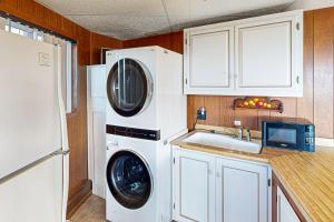 a kitchen with a washing machine and a sink at Carousel House in Pacific City in Pacific City