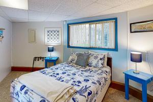 a blue and white bedroom with a bed and two tables at Carousel House in Pacific City in Pacific City +20 photos