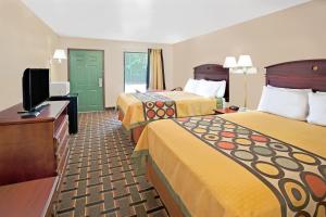 a hotel room with two beds and a flat screen tv at Super 8 by Wyndham Acworth/Atlanta Area in Acworth