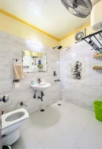 a bathroom with a sink and a toilet and a shower at Pearl of Nature By Nyra in New Delhi