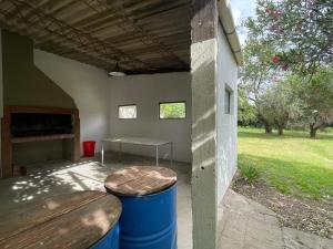 a covered patio with a table and a bench at Casagrande Navarro in Navarro