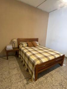 a bedroom with a bed and a side table at Casagrande Navarro in Navarro