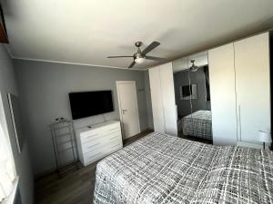 a bedroom with two beds and a flat screen tv at bilocale con NETFLIX INCLUSO in Lodi +2 photos