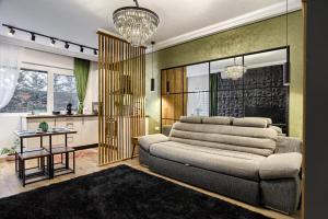 a living room with a couch and a table at Sika Onyx Garden Apartment - cazare Arad - self check-in in Arad