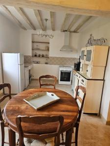 a kitchen with a table with a laptop on it at Holy Cottage in Sainpuits