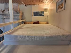 a small bedroom with a bed in a room at Kodikas Studio in Tampere